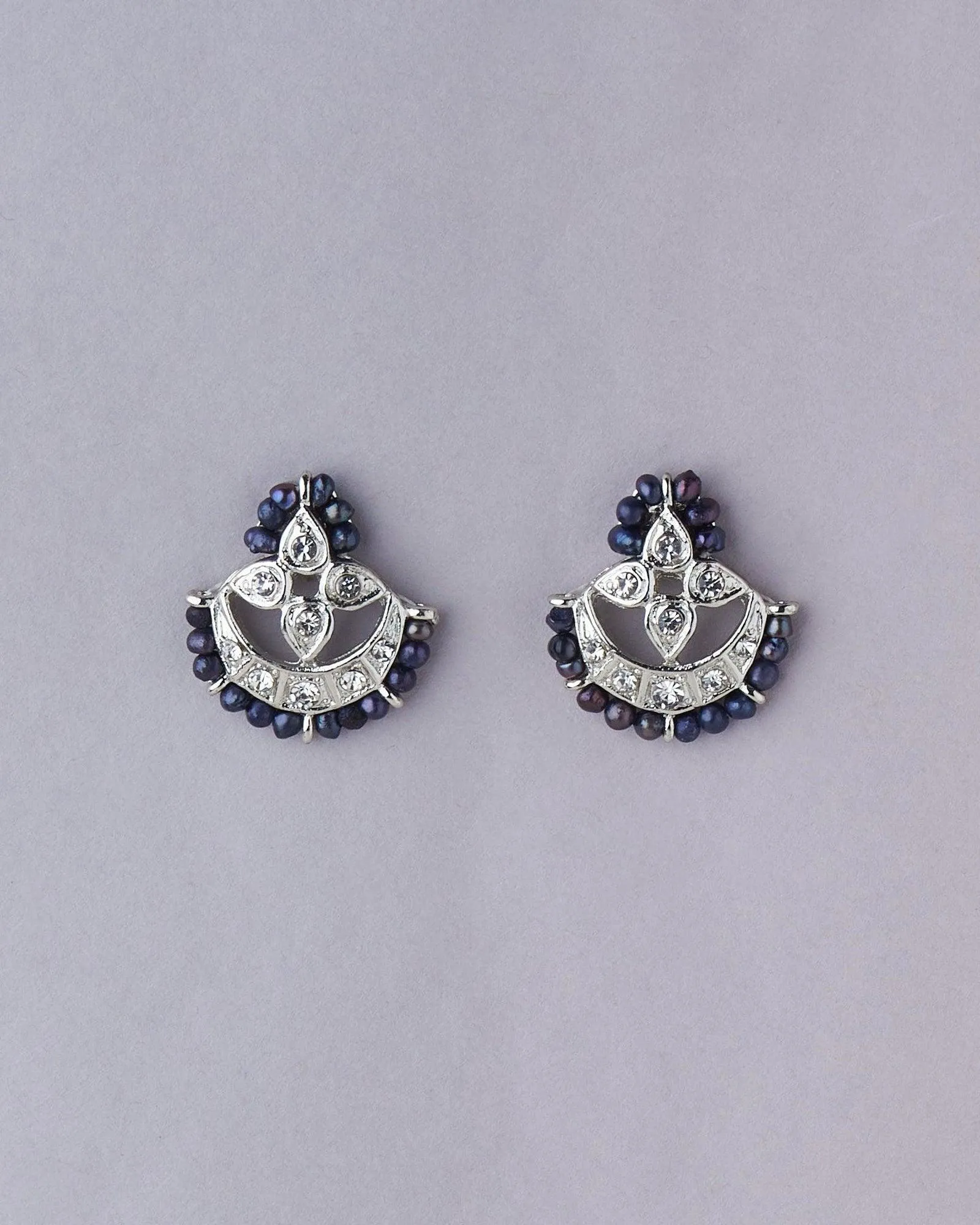 Elegant pearl with stone studded stud earrings that always go with your traditional outfit.