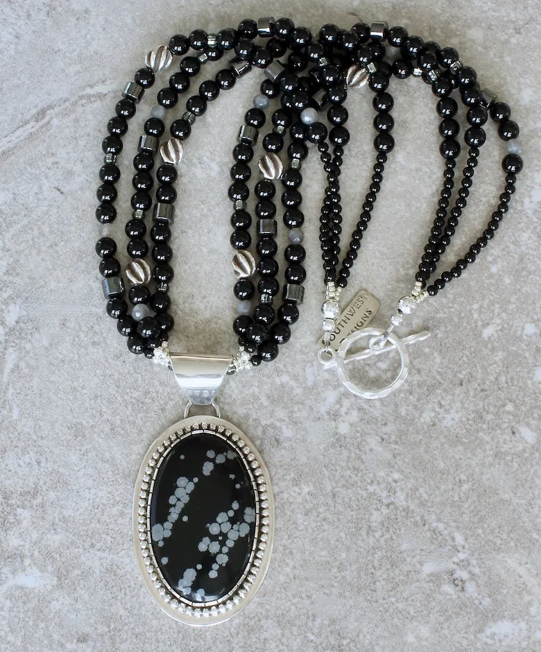 Snowflake Obsidian and Sterling Silver Oval Pendant with 3 Strands of Black Onyx Rounds, Hematite Drum Beads, Hill Tribe Silver Spiral Ovals, and a Hammered Sterling Silver Toggle Clasp