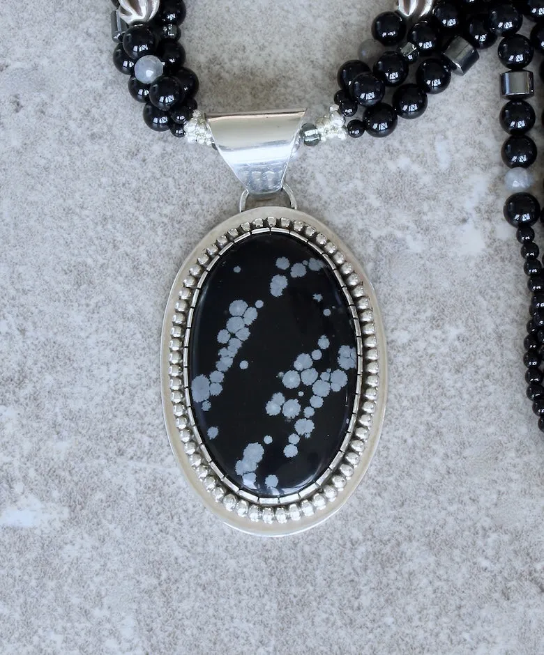 Snowflake Obsidian and Sterling Silver Oval Pendant with 3 Strands of Black Onyx Rounds, Hematite Drum Beads, Hill Tribe Silver Spiral Ovals, and a Hammered Sterling Silver Toggle Clasp