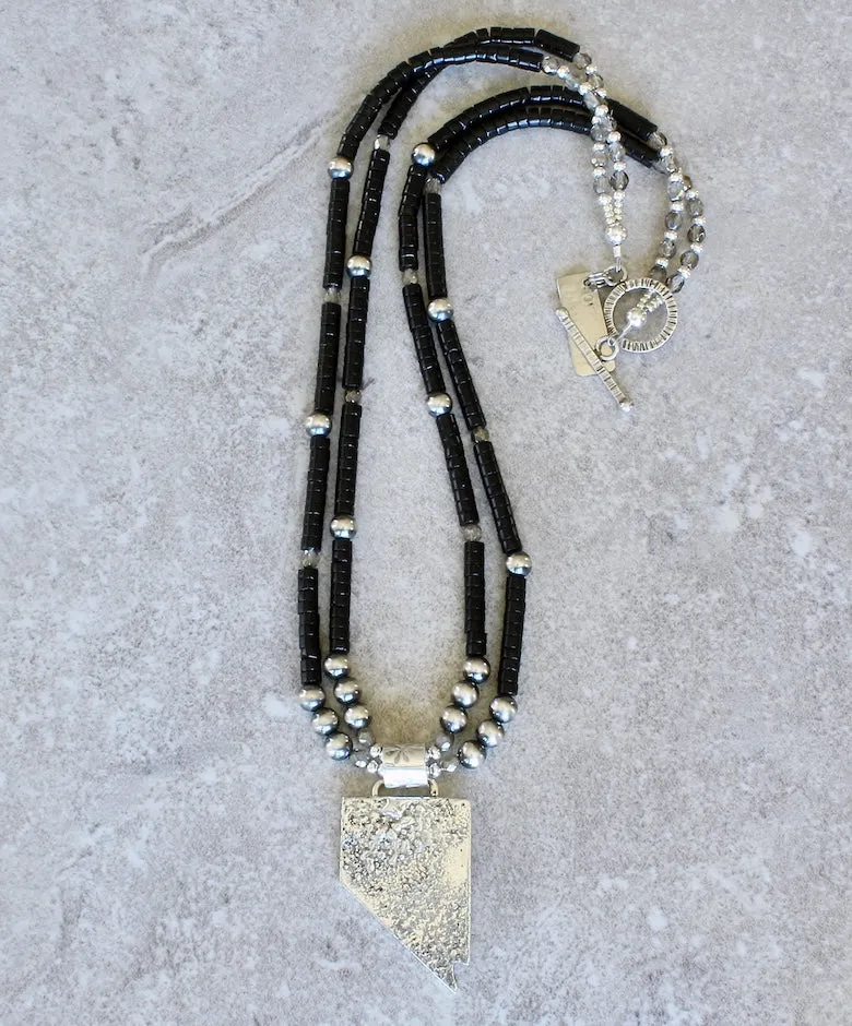 State of Nevada Reticulated Silver Pendant with 2 Strands of Black Onyx Heishi, Oxidized Sterling Silver Rounds, and a Sterling Silver Toggle Clasp